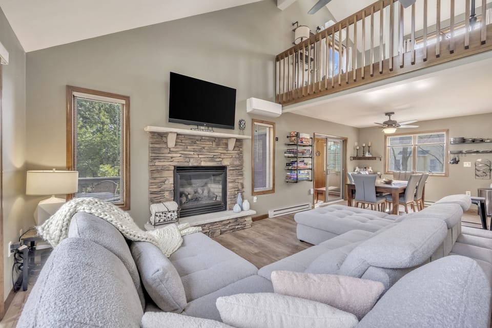 Living Room with Sofa-bed, smart TV, electric fireplace, books, board games