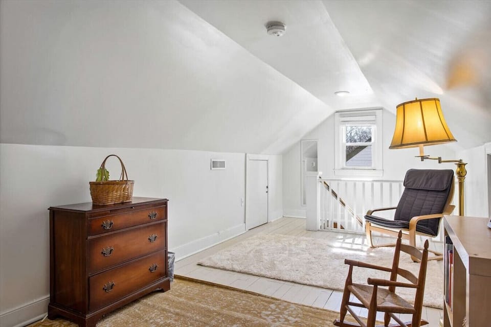 A dreamy upstairs nook with two single beds, cozy seating, and soft lighting—perfect for afternoon naps or a peaceful night’s sleep.