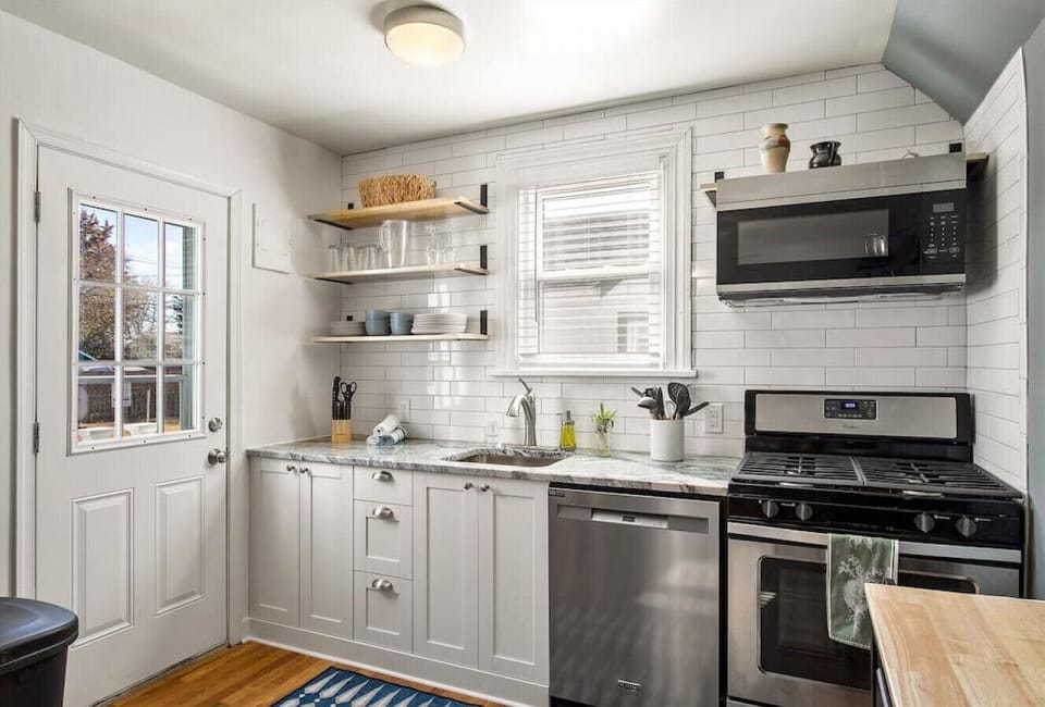 Fully stocked and ready for your culinary adventures! Features a microwave, dishwasher, and easy access to the backyard.