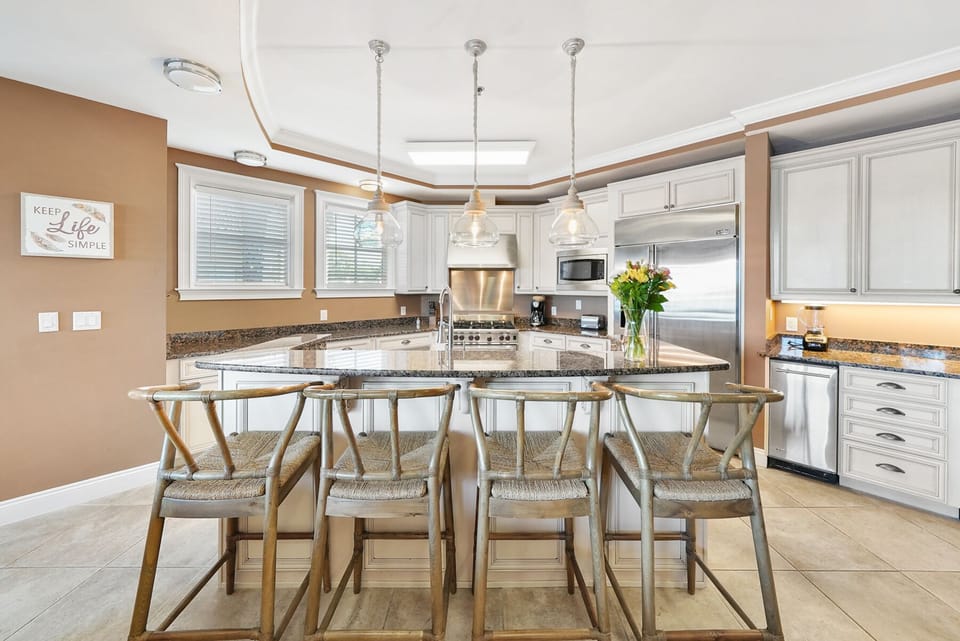 Your gourmet kitchen awaits with granite counters, modern appliances, and breakfast bar perfect for morning coffee conversations.