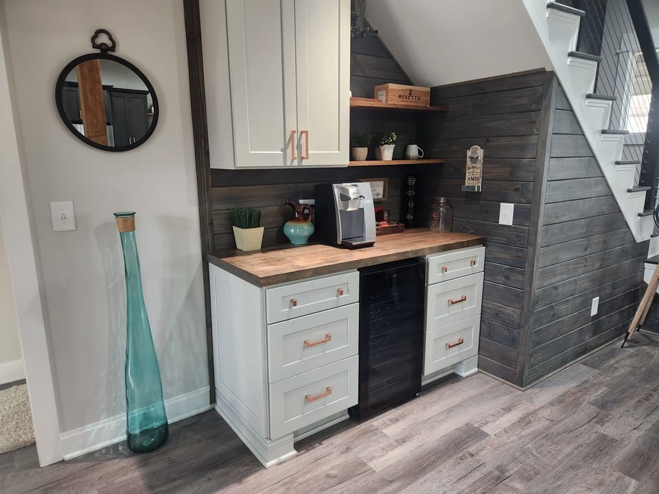 Beverage bar with hard-plumbed Keurig and under counter cooler.