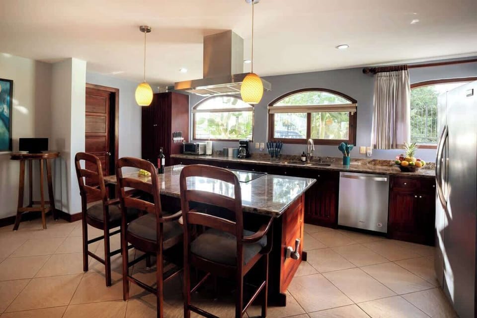 Fully equipped gourmet kitchen with granite countertops and modern appliances.