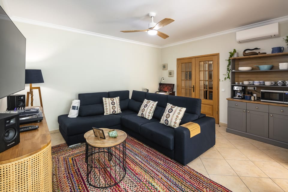 Lovely living room with sectional couch, large screen TV, record player & games
