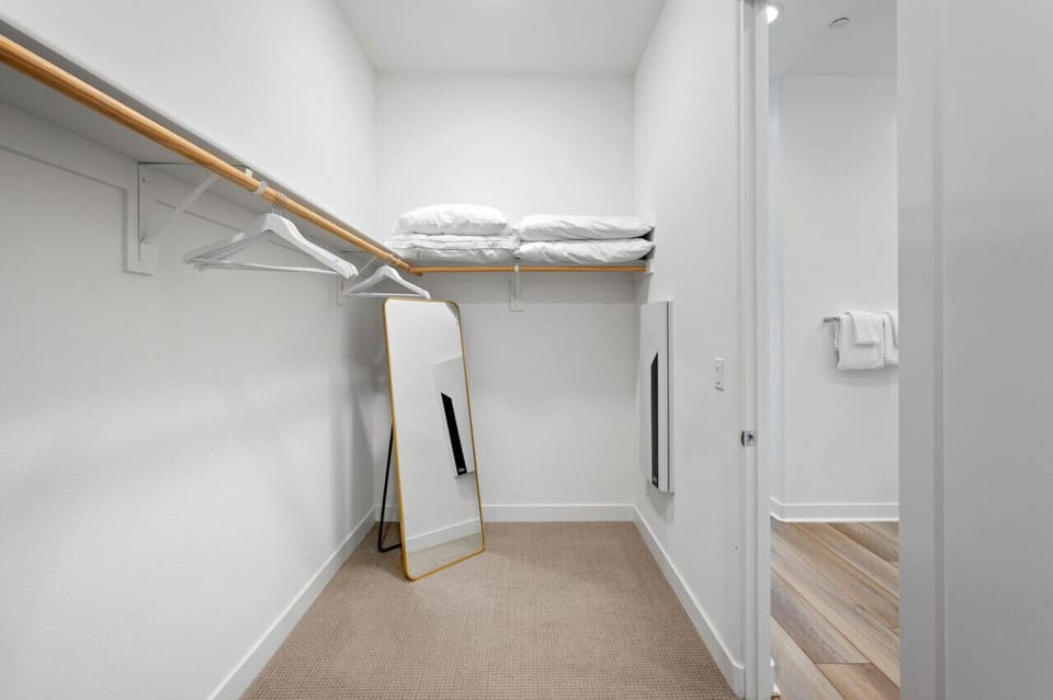 Organized closet space w/ hanging racks & shelves for easy unpacking