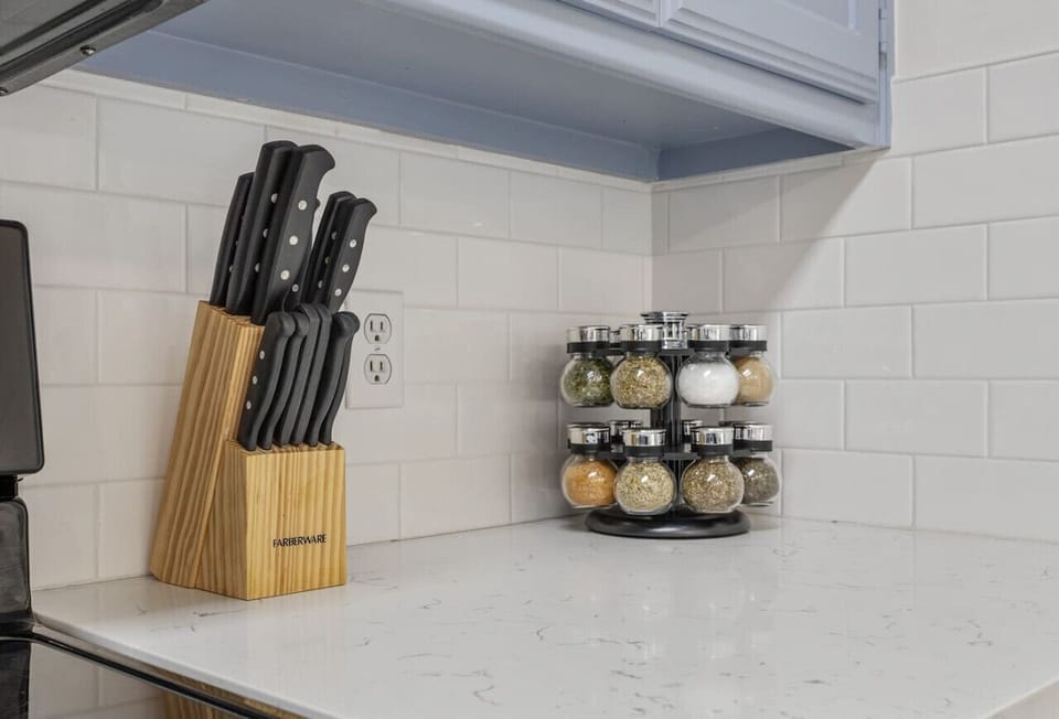 This bright, modern kitchen has everything you need to feel at home. Cook with ease using stainless steel appliances, a complete cookware set, and a sharp knife block. A rotating spice rack and starter seasonings make it easy to bring flavors to life, whi