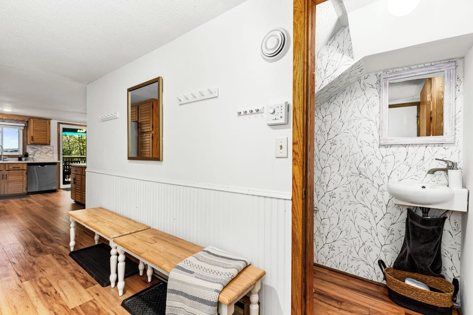 As you step through the front door, you'll find an open entryway and half bath