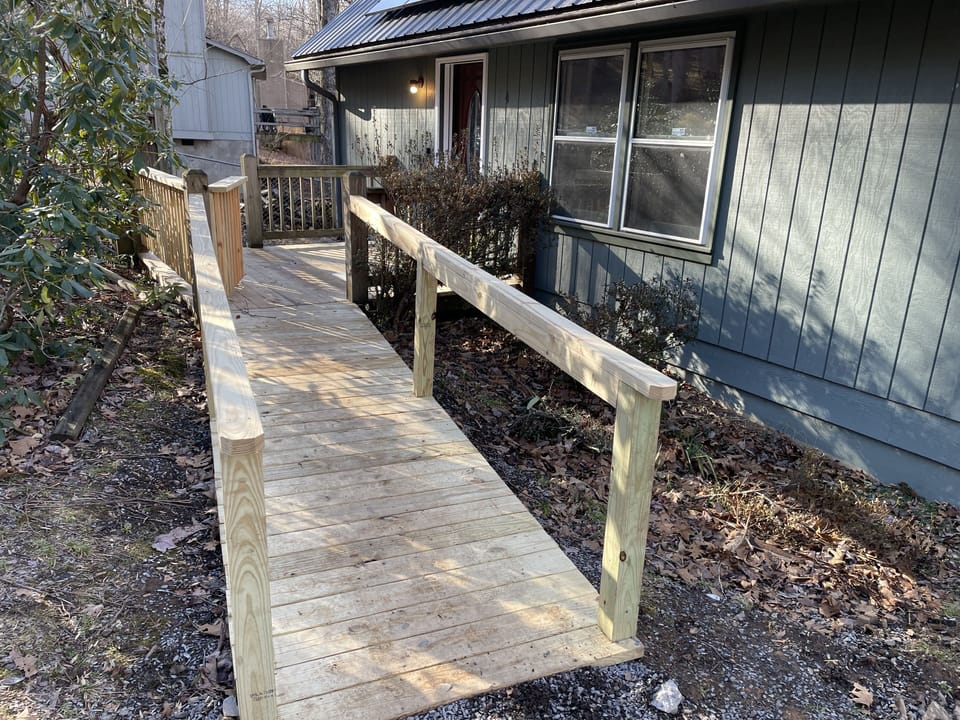 Nearly level ramp from nearly level driveway. No step into house.