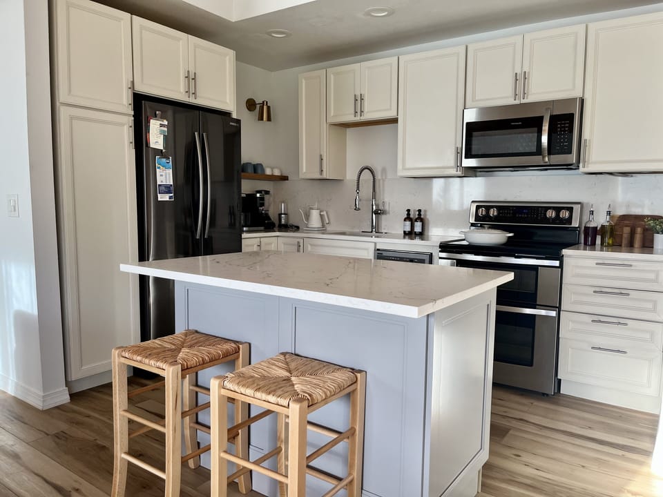 Kitchen area with spacious island with built in pull-out double garbage bins.