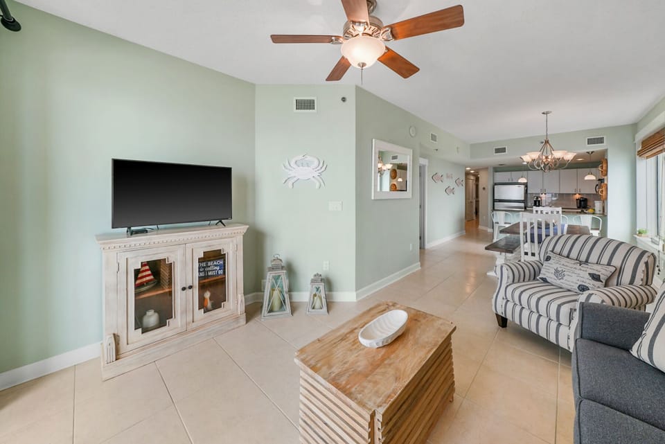 Sink into coastal comfort in your bright, open living space with soothing mint walls and beachy decor.