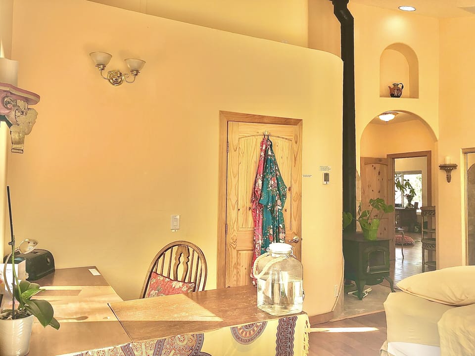 The glass-doored wood stove can be seen from the bed, desk and jacuzzi. 