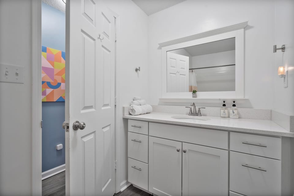 Huge bathroom with quartz counter top and full sized bathtub and shower combo. Body & hair wash, towels, toilet paper and hair dryer all available to get you started.