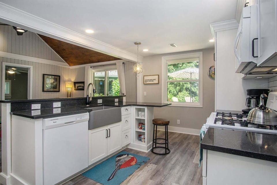Kitchen has a dishwasher, range, coffee maker, and more