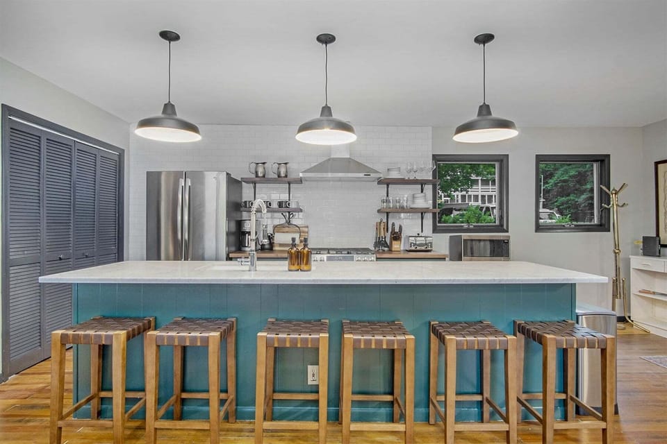 Beautiful brand new kitchen with marble counters and stainless appliances
