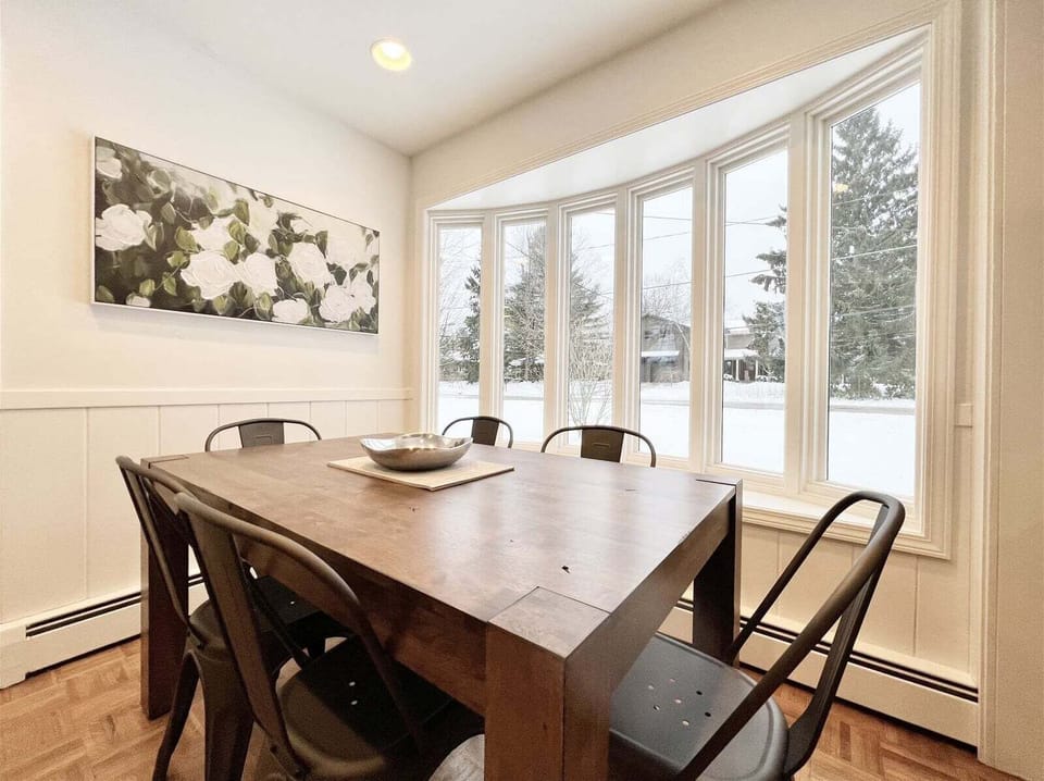 Dining nook has big windows overlooking the yard