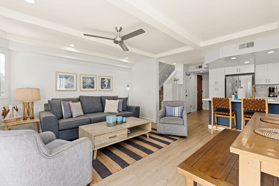 Featuring contemporary seating and light wood accents, this living space exudes warmth and tranquility.