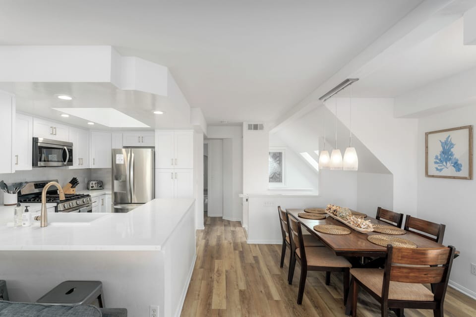 This modern, light-filled dining and kitchen area is the perfect spot for enjoying time with family or friends.