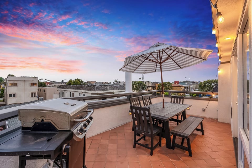 This generous Outdoor space features ample seating for Dining and a high-end Grill.