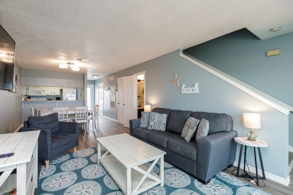 Sink into your plush sectional after beach days in this coastal-themed living space where nautical blues and seaside touches create the perfect retreat.
