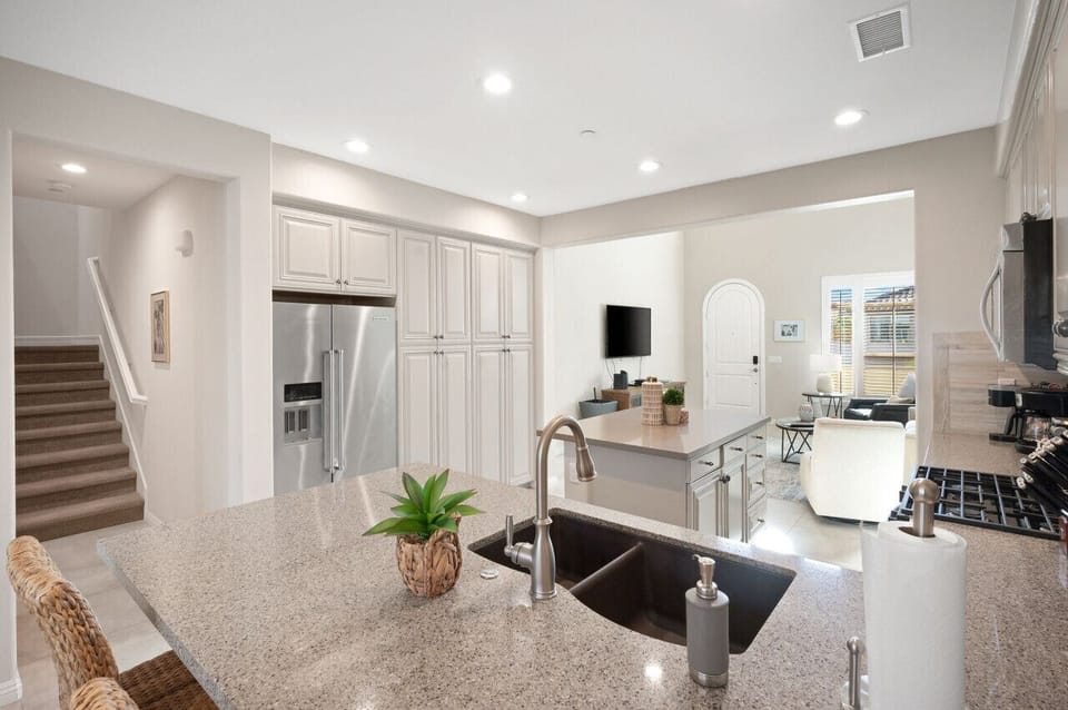 Open kitchen w/ large island, bar seating & modern appliances for easy entertaining