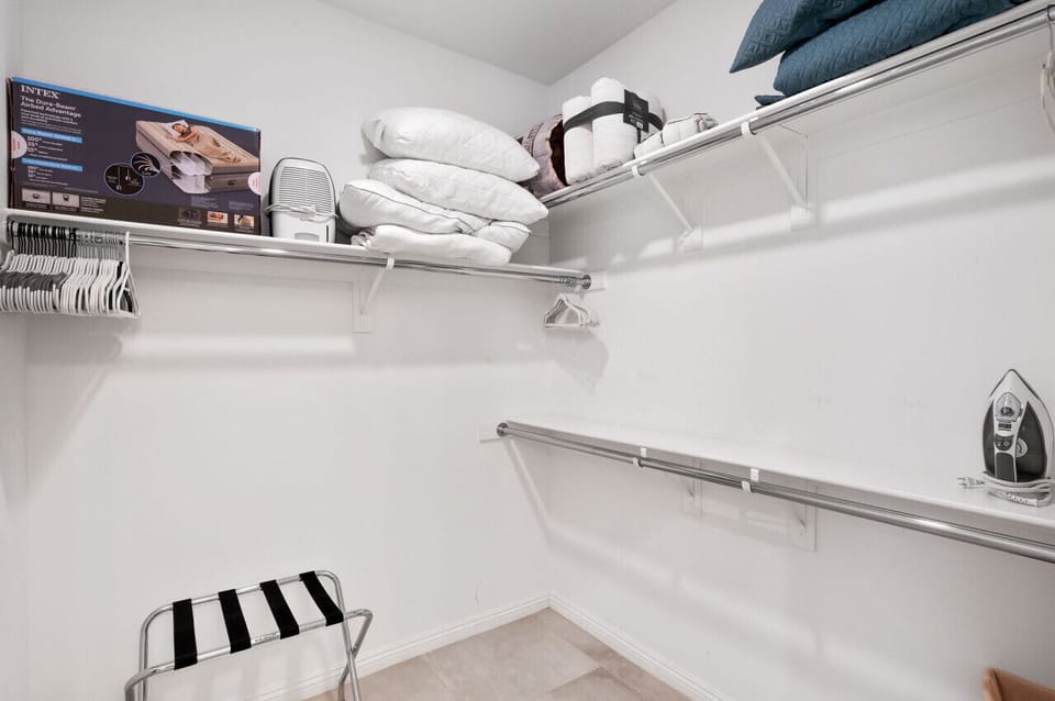 Walk-in closet w/ shelves & hanging space to keep everything organized