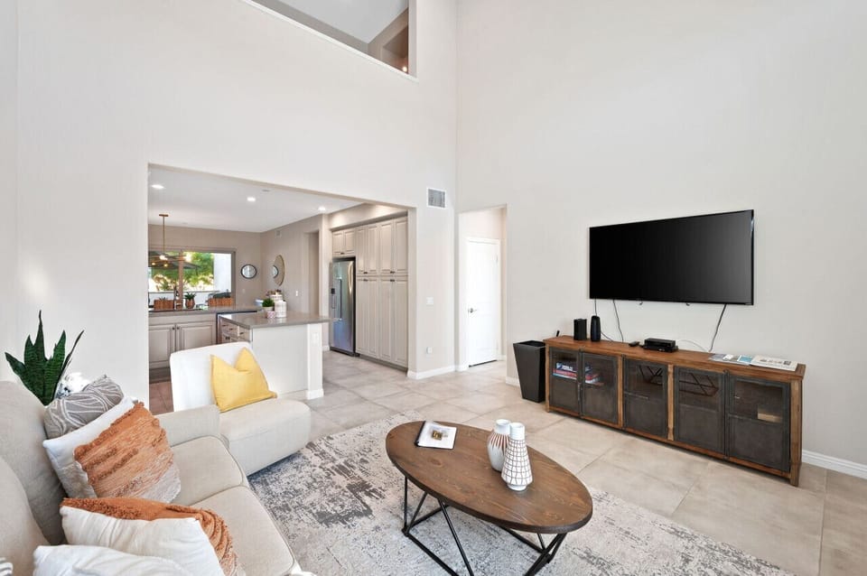 Spacious living area w/ comfy sofas, wall-mounted TV & open layout for gathering