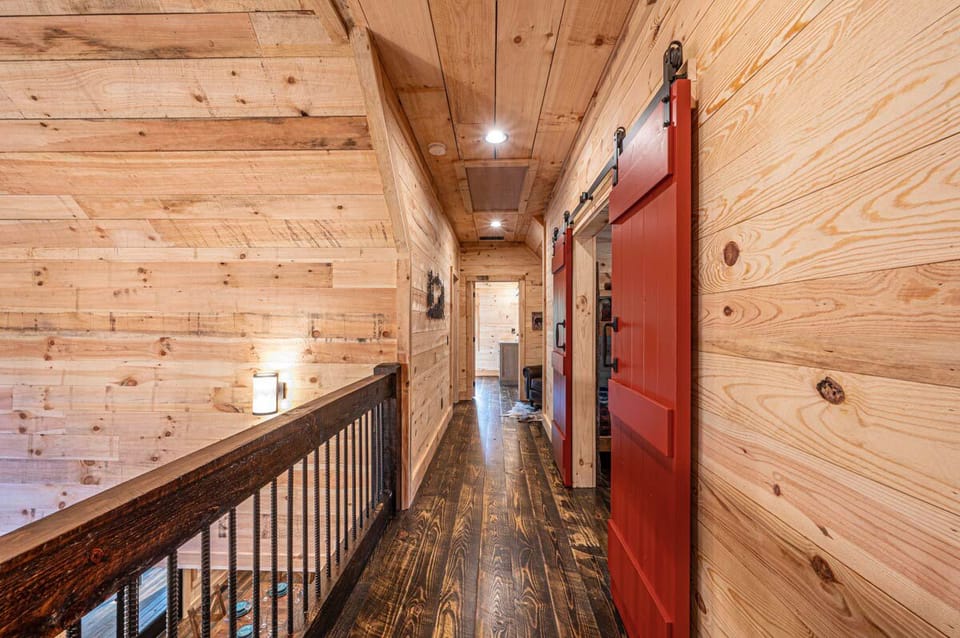 Balcony overlooking main floor family room & two story stone fireplace