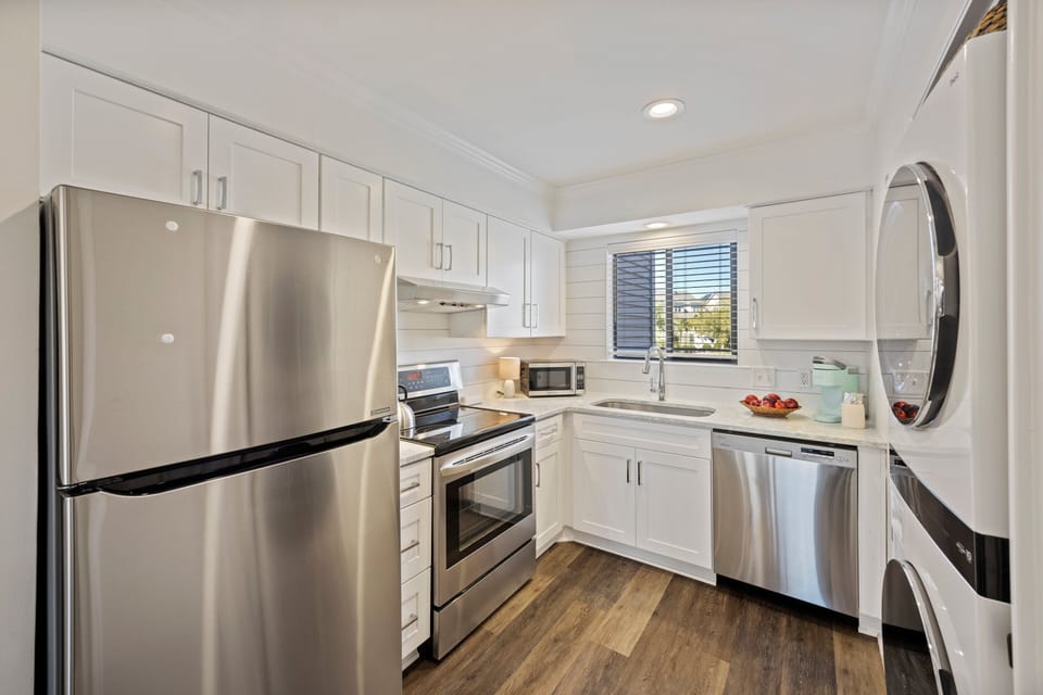 Fully equipped, modern kitchen with stainless appliances.