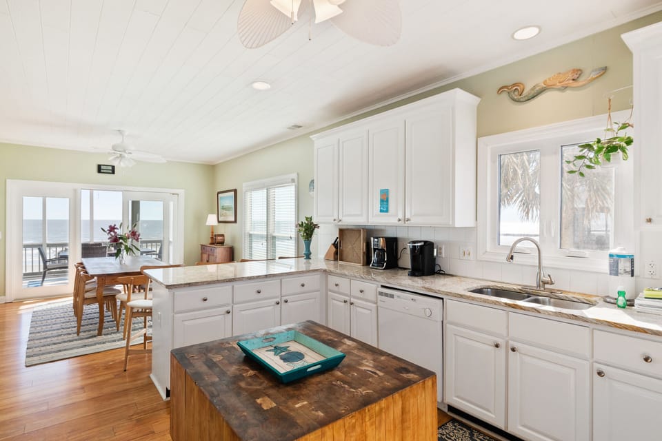 Well-appointed kitchen featuring a breakfast bar with seating for four, perfect for casual dining, morning coffee, or gathering while meals are prepared.