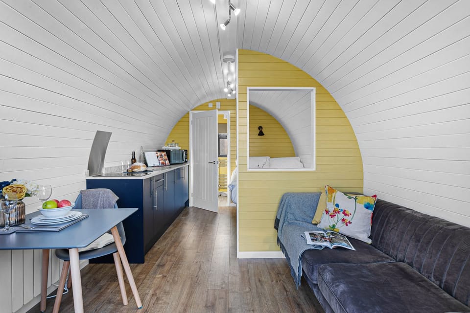 Living area with sofa, dining table and counter top - Honeycrisp Pod