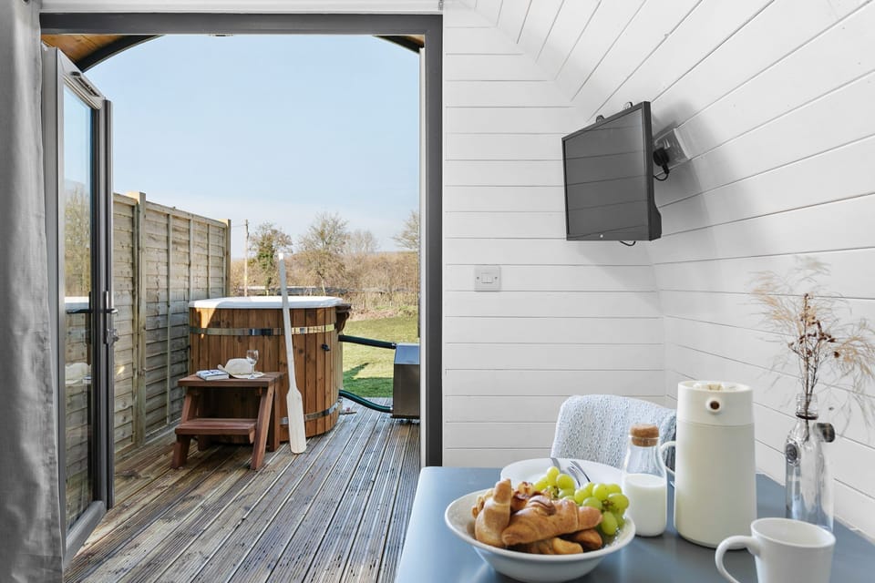 Smart TV in the Living area with a view of the Hot tub - Windsor Glamping Pod