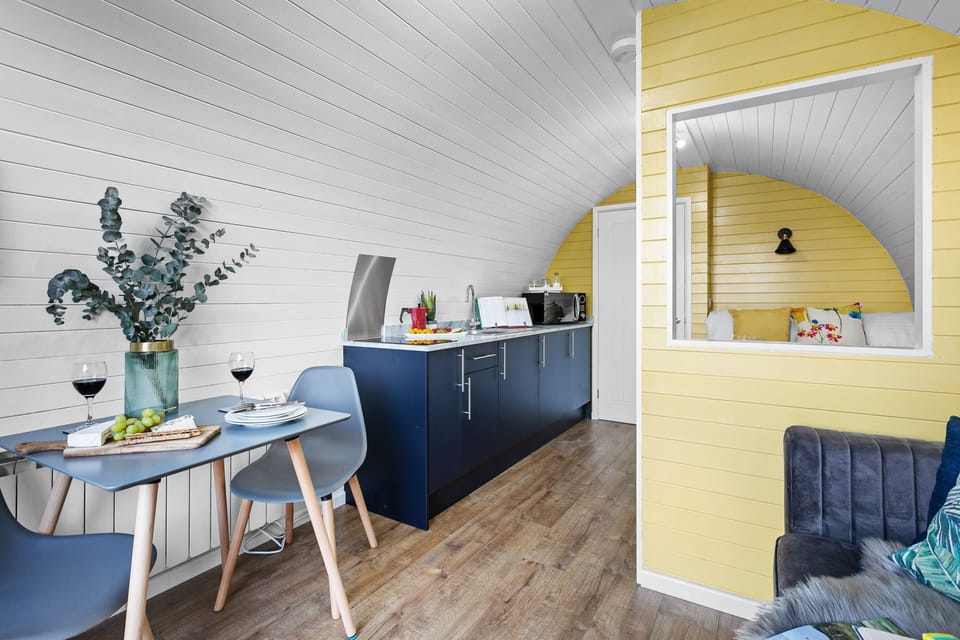 Dining table with a plant on and kitchen facilities - Morgan Sweet Glamping