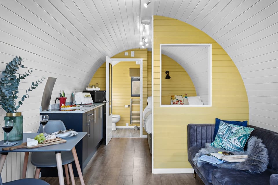 Living area with dining table, sofa and counter top - Morgan Sweet Glamping