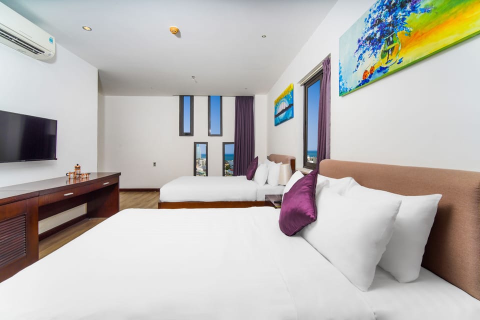 Deluxe Family Room | Minibar, in-room safe, desk, laptop workspace