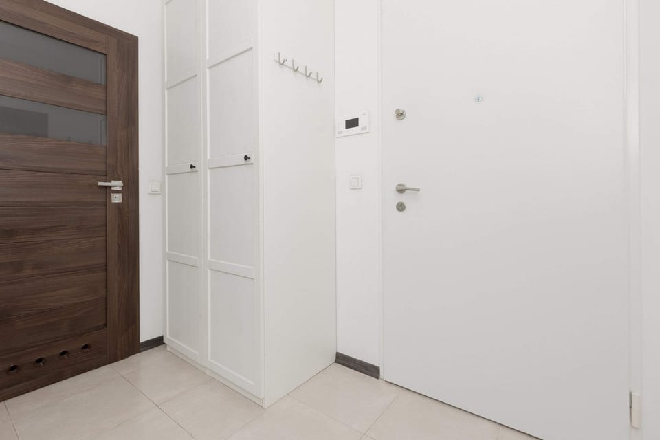 Hallway with wardrobe and clothes hangers.
