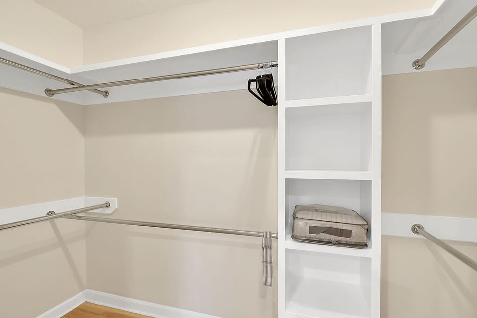Walk-In Closet In Guest Suite - Walk-in closet for the second king suite with open shelves, hanging rods, and space to unpack.