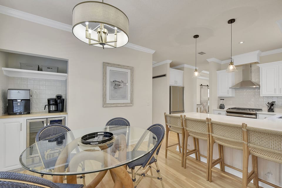 Dining Room And Coffee Station - Round dining table, island seating, drip coffee setup, and filtered water near the kitchen for easy meals and mornings.