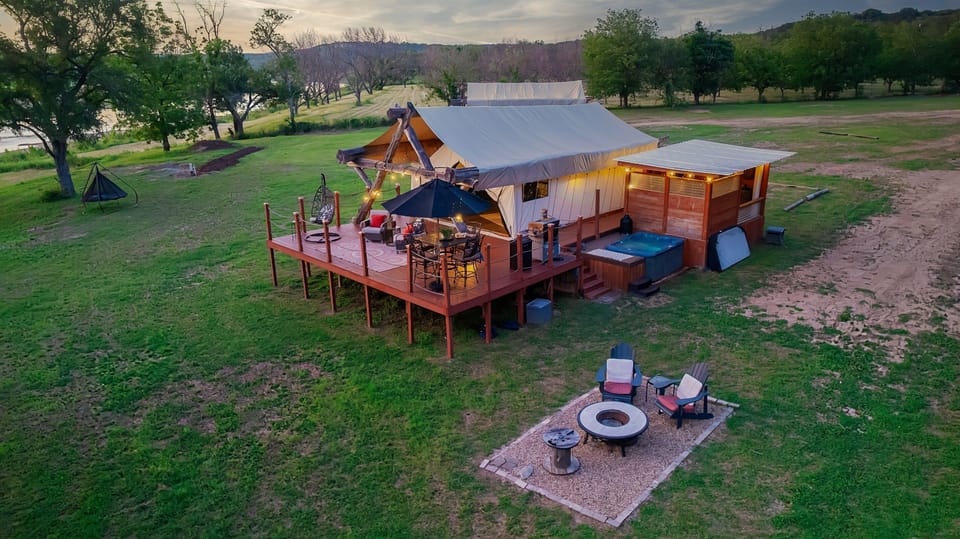 Drone view of the tent, patio,hot tub, fire pit