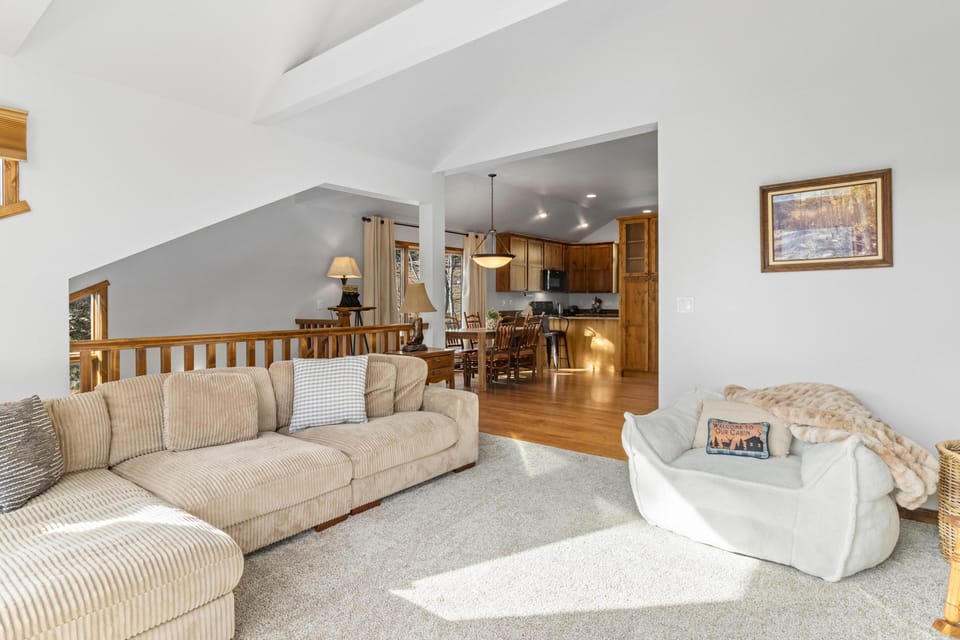 Cozy living room with vaulted ceilings and open layout
