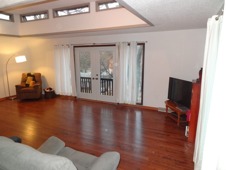 Living room with couch, recliners, and Roku smart TV