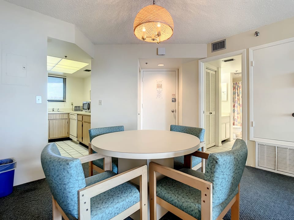 The dining room table has room for 4 guests.