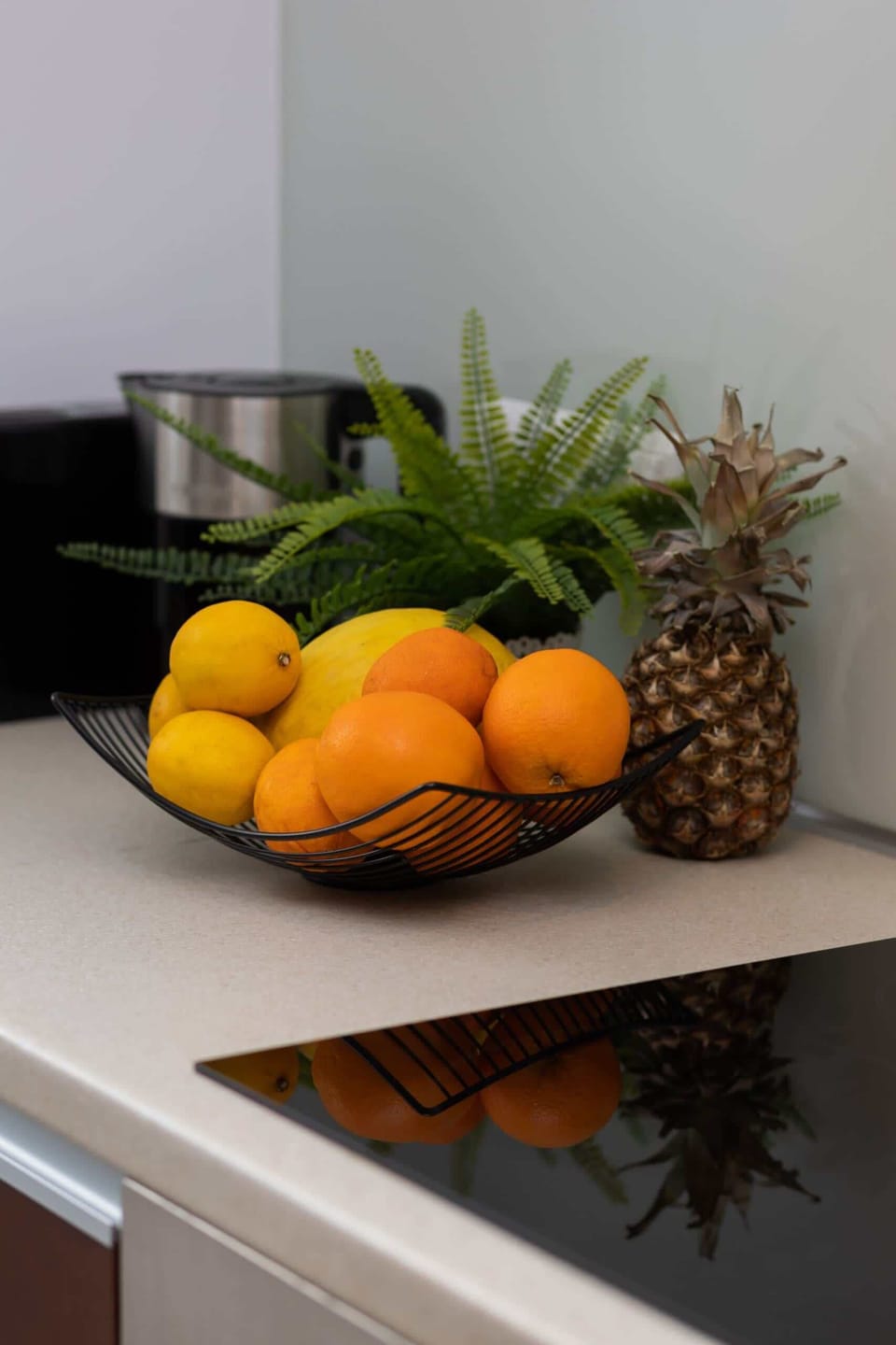 A bowl of fresh fruits (oranges and bananas) placed on a counter for a pop of color.
