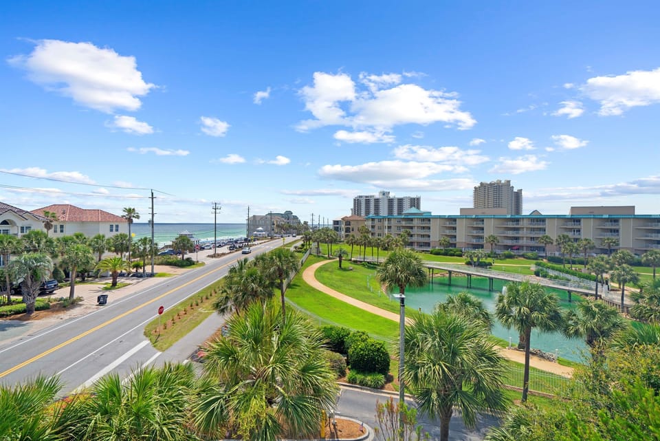 Gorgeous elevated view of Scenic Gulf Drive, palm trees, and the shimmering ocean just steps away.