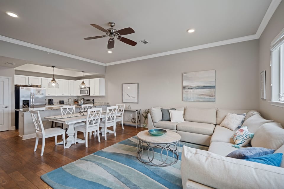 Bright and airy living space featuring plush seating, flat-screen TV, and stunning views of the Gulf right from your couch.