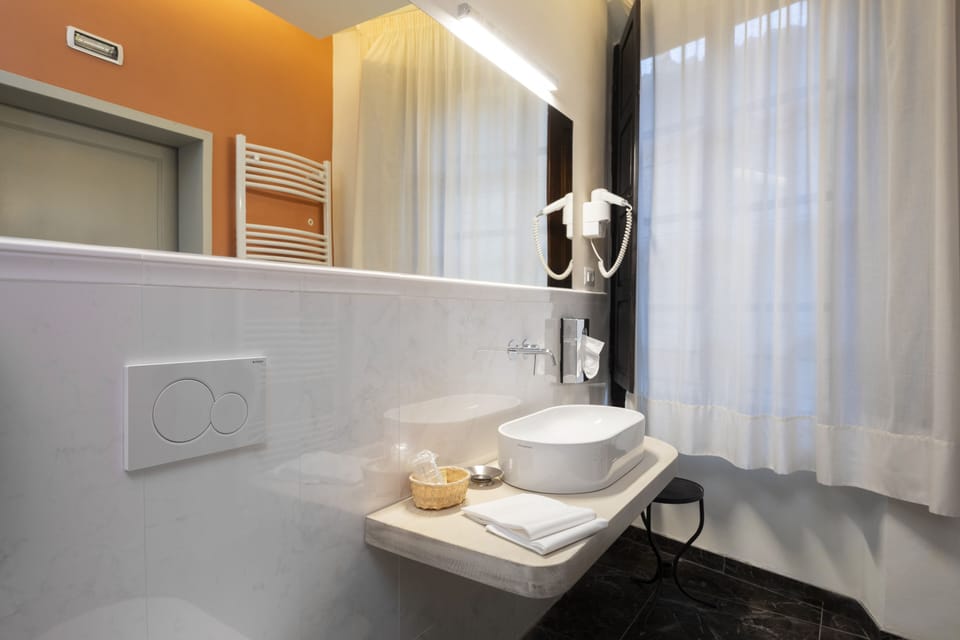Junior Quadruple Room, 2 Bedrooms | Bathroom | Rainfall showerhead, free toiletries, hair dryer, bidet