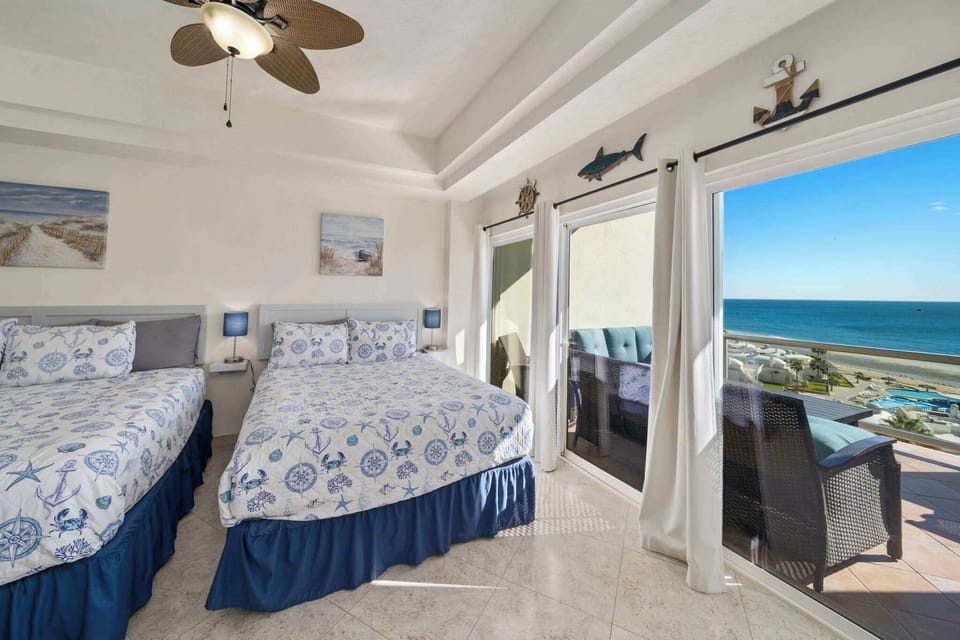 Wake up to stunning ocean views from this bright and spacious bedroom with direct patio access.