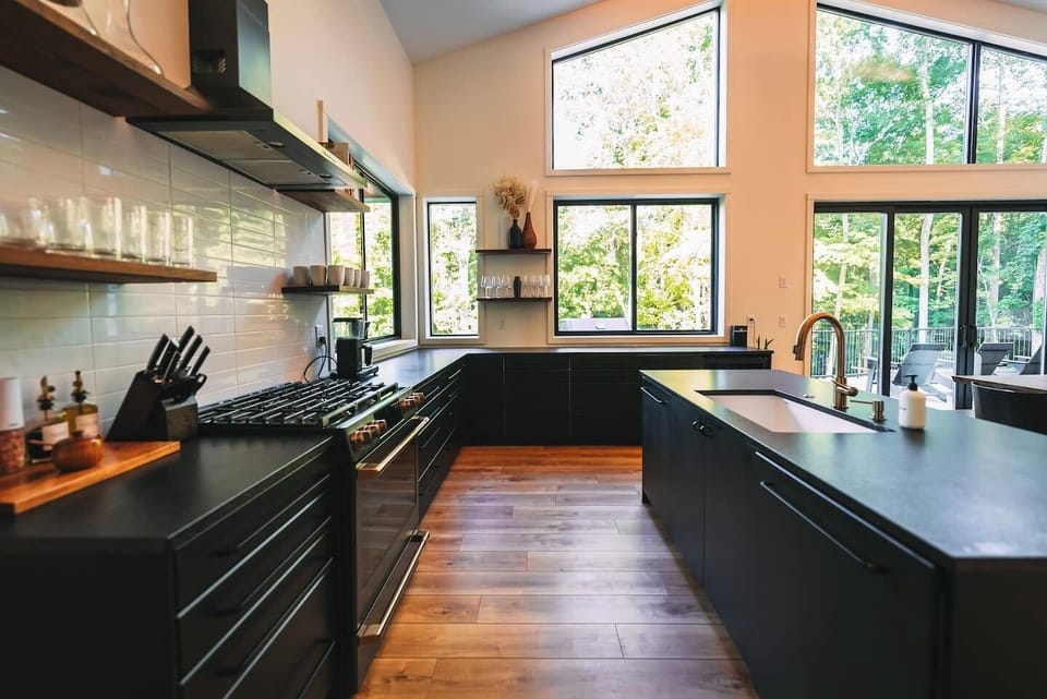 View of kitchen range, sink, and ample storage and countertop space