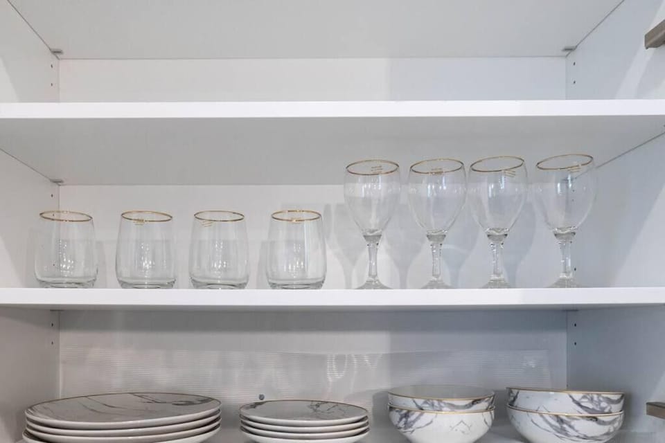 View of the open concept kitchen cabinets and glassware 