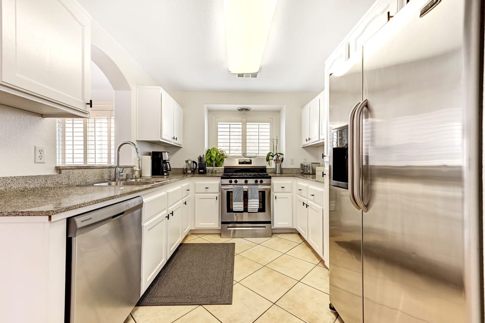 A full kitchen with features including a Cuisinart coffee machine & toaster.