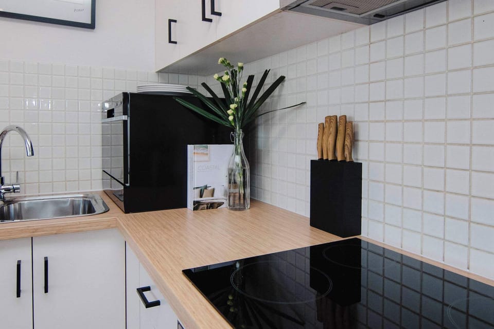Fully equipped kitchen with Fridge, freezer, dishwasher, microwave, tea and coffee making facilities, stove top and oven