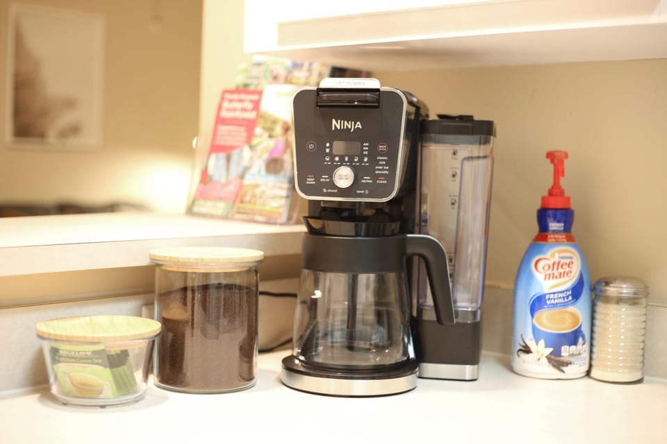 Kickstart your morning with our fully stocked coffee station—everything you need is right here.